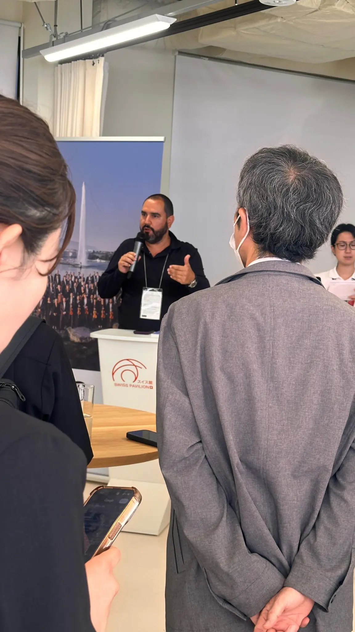 Presentation of Virtual Hall at the microphone in the Swiss Pavilion event space in Osaka.